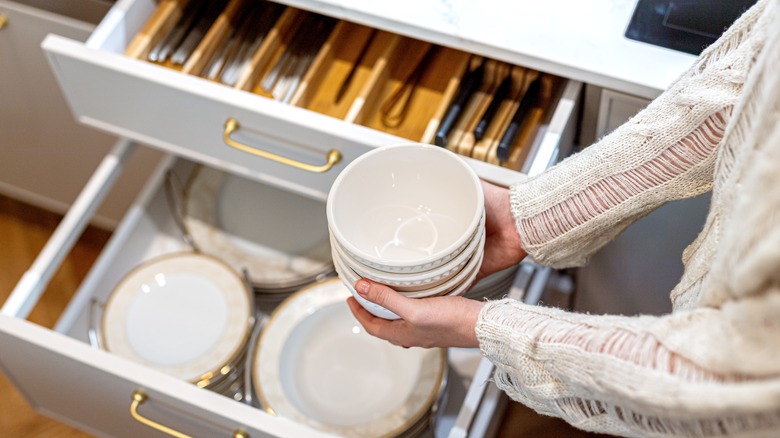 Plates and bowls in deep kitchen drawer