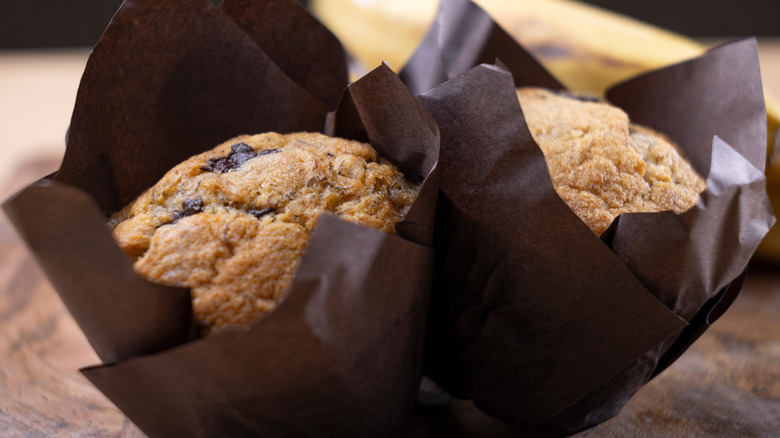Baked banana chocolate chip muffins, wrapped in parchment paper