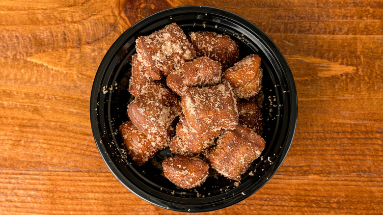cinnamon sugar churro bites on black plate