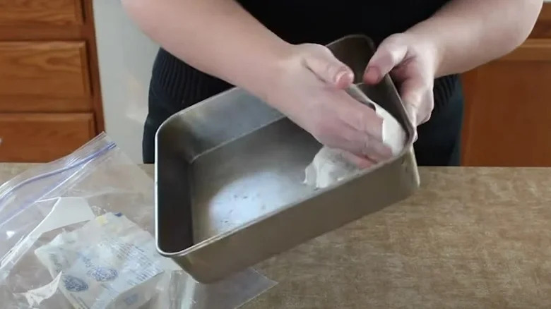 Greasing pan with butter wrapper