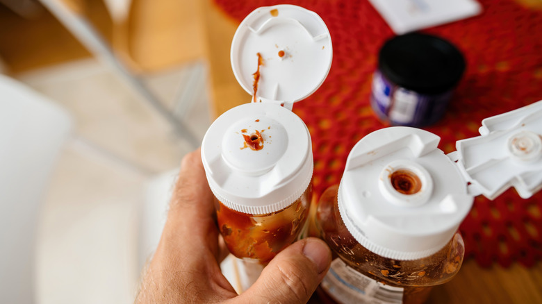 Plastic ketchup bottles with open lids