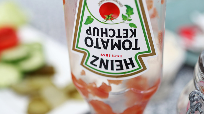Upside down Heinz squeezable ketchup bottle that is empty.