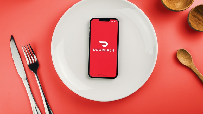 DoorDash app on phone on plate