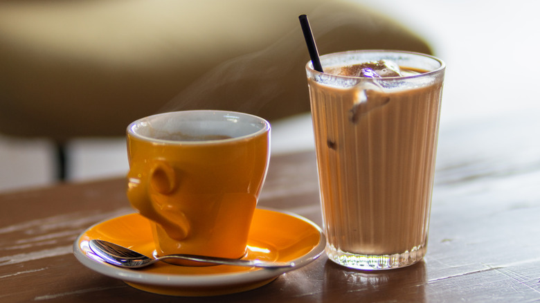 A mug of hot coffee and a glass of iced coffee