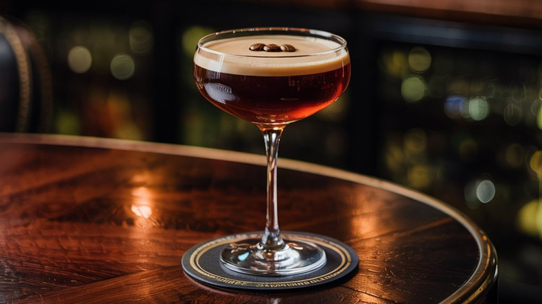 An espresso martini on a wooden bartop