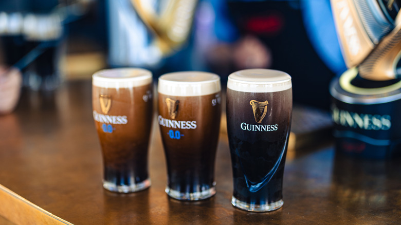 Three pints of Guinness on a bartop