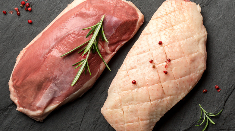 Raw duck breast on plate
