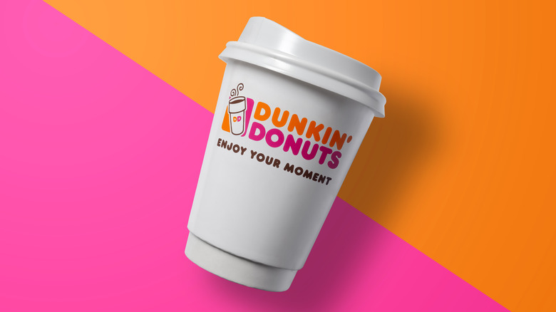 Dunkin' cup on orange and purple background