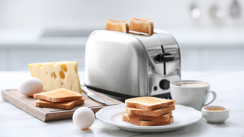 modern toaster with breakfast ingredients