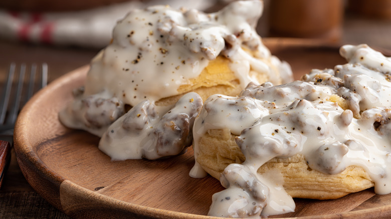 Biscuits and gravy on wooden plate