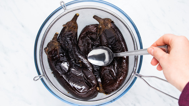 eggplants draining in sieve
