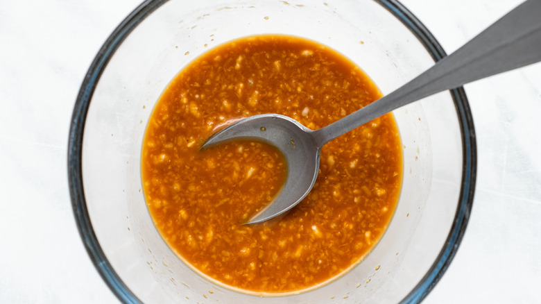 red sauce in a bowl with a spoon