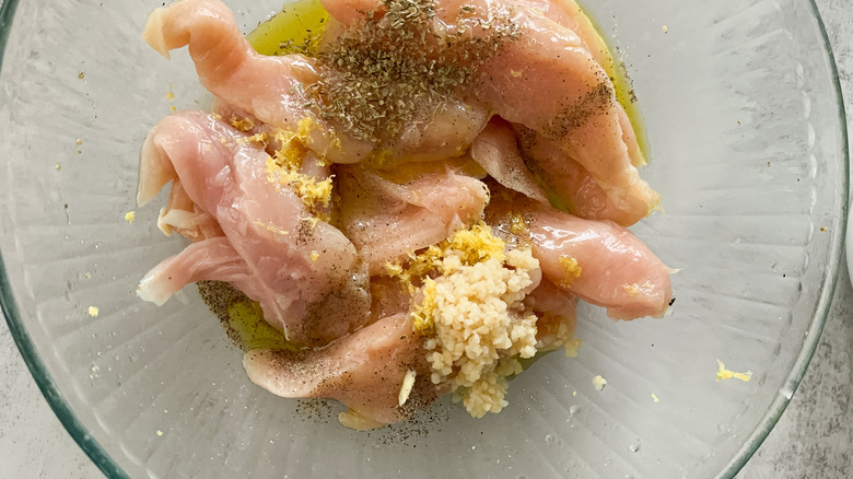 lemon chicken in bowl before stirring
