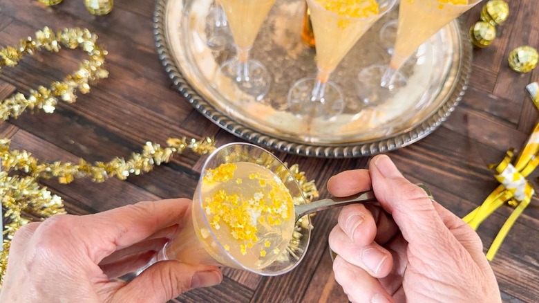 Champagne jell-o shot with edible gold stars in mini flute