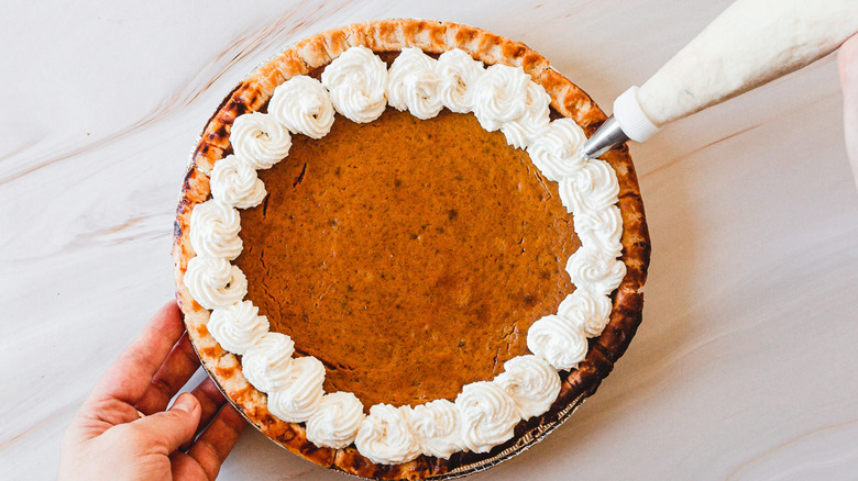 piping whipped topping around pie
