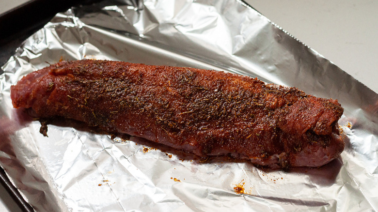 uncooked, seasoned pork tenderloin