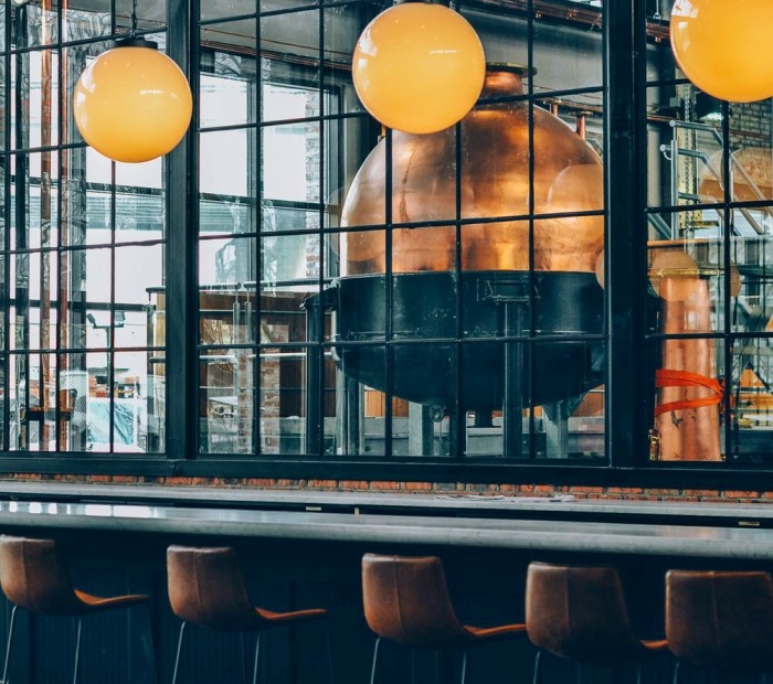 Pizza Brain has an outdoor seating area in the back decorated with art.