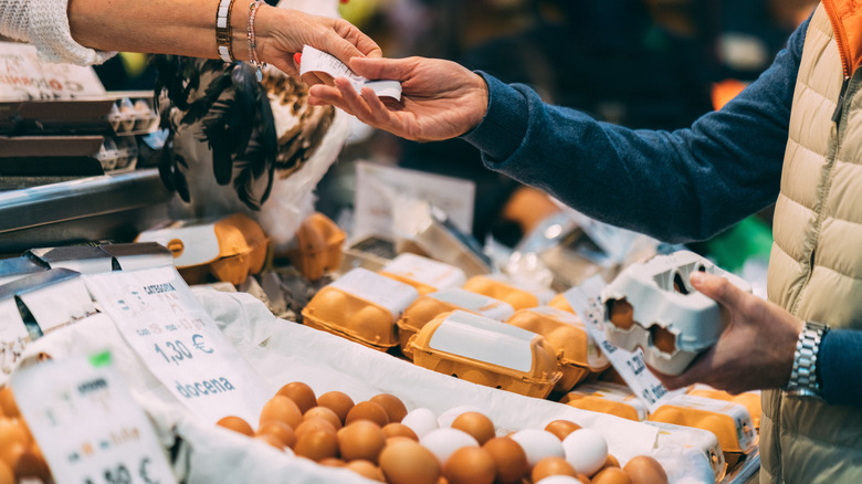 Customer buying eggs from clerk