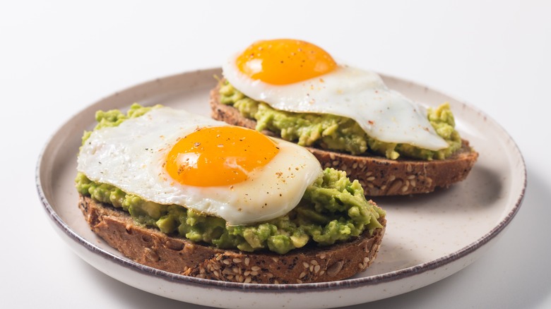 open faced egg over easy with avocado and toast