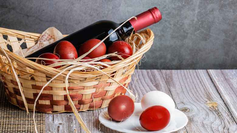 Wine bottle and eggs in basket