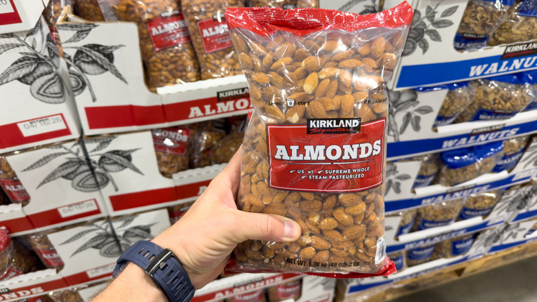 large packs of almonds and walnuts on display in a costco store