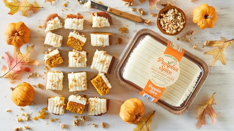 Pumpkin spice sheet cake with slices of cake and tine pumpkins on board