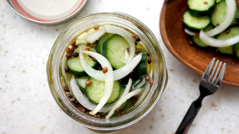 jar plate of cucumbers, onions, and spices