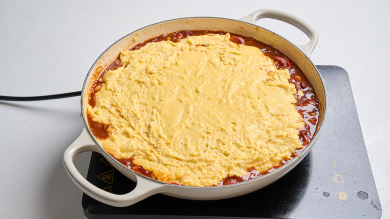 cornbread topping spread across casserole