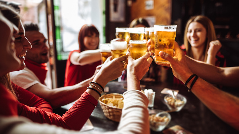 People cheers beer in a pub