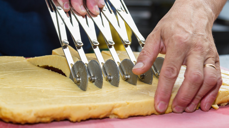 Person rolling out panisses