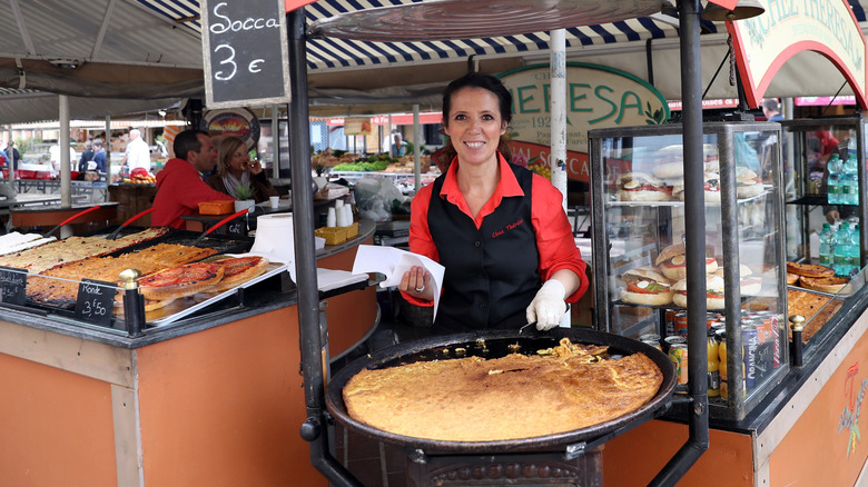 Woman with socca stand