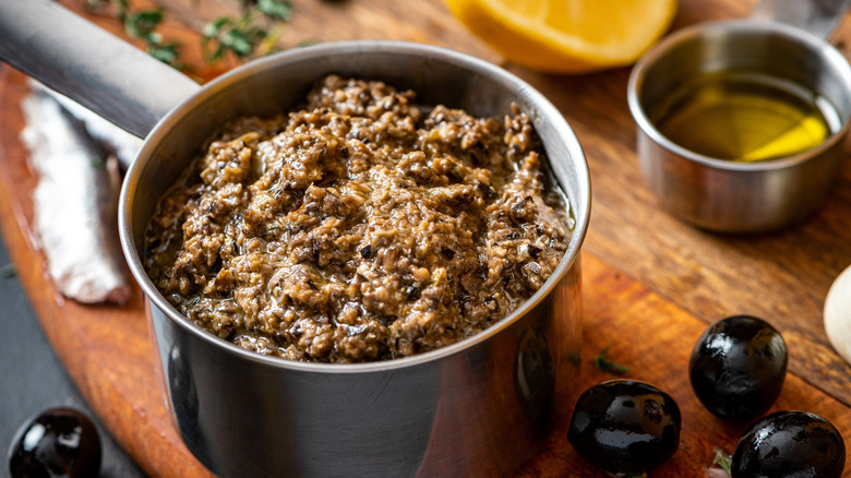 Saucepan of tapenade with oil and olives