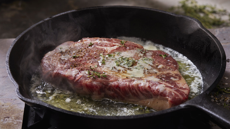 steak searing in cast iron skillet