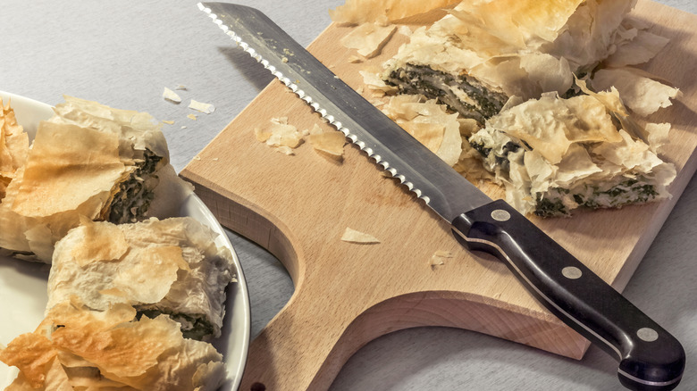 serrated knife on cutting board