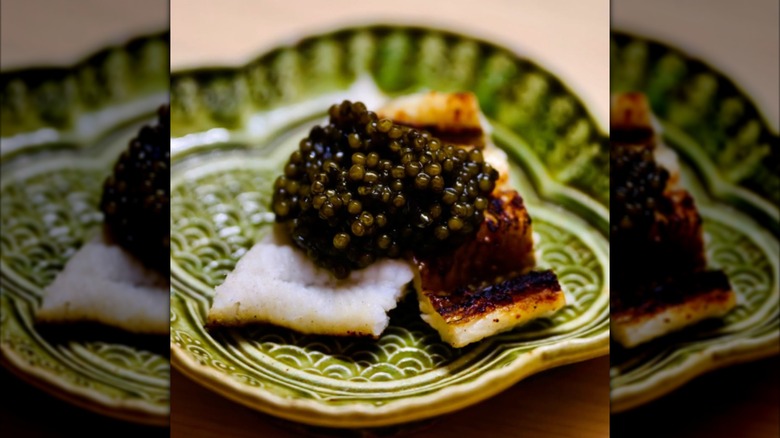 Sushi and caviar on a green plate