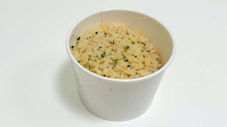 A to-go container of Outback Steakhouse Seasoned Rice