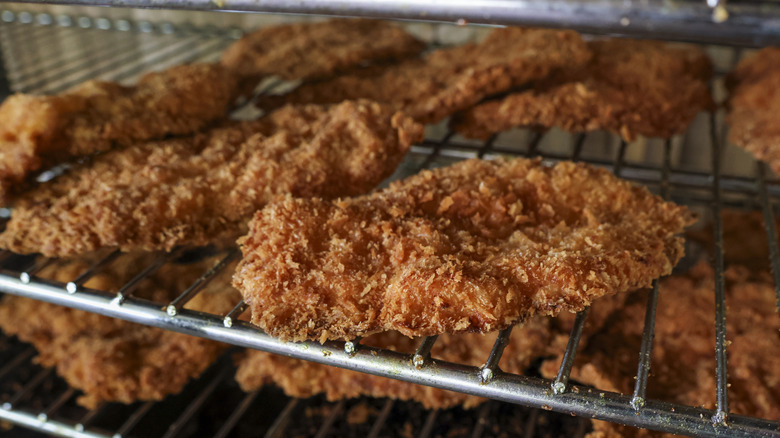 Fried chicken pieces placed as-is on an oven rack