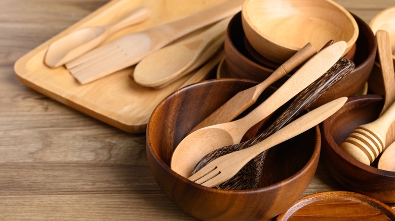 Wooden bowls, spoons and board on a table
