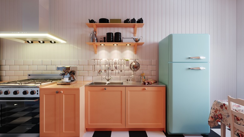 a clean kitchen with stove and cabinets and a powder blue vintage freezer-top fridge