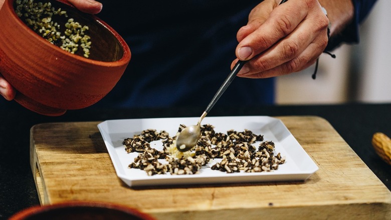 Wojciech Amaro plating a dish