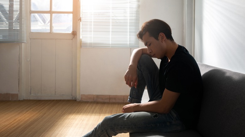 Troubled young man on couch