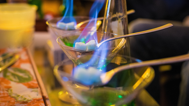 Flaming sugar cubes in glasses