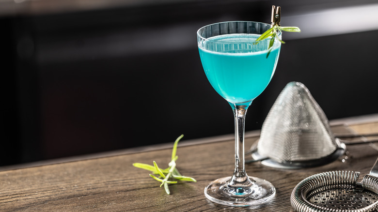 A blue cocktail on a bar