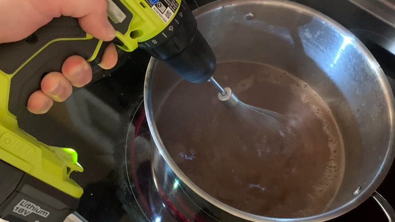 Using a whisk in a power drill to stir hot chocolate