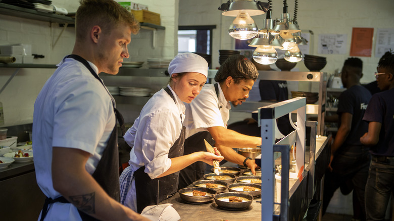 Chefs working in kitchen