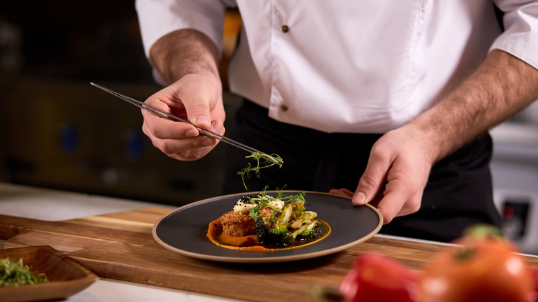 A chef plating food
