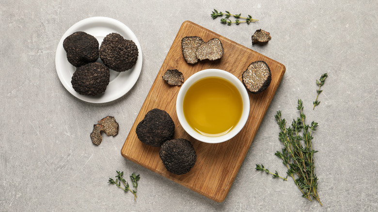Fresh truffles, with ramekin of oil and sprigs of rosemary