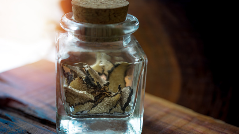 Dry slices of truffle in glass jar