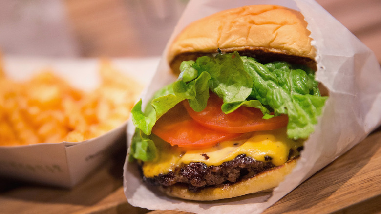 a Shackburger from Shake Shack with a side of fries on a wooden table