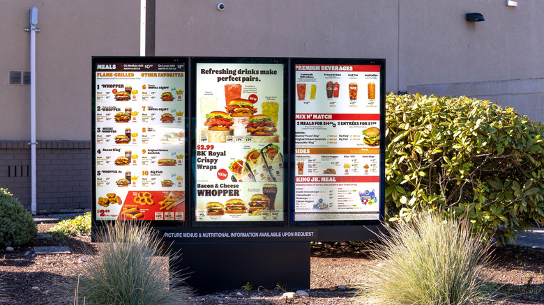 Burger King drive thru menu, with bushes surrounding it